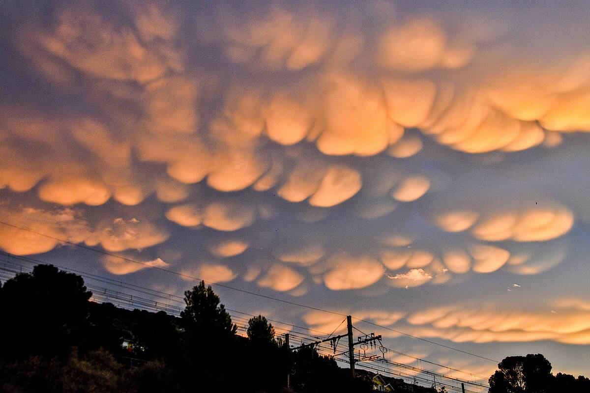 Mammatus clouds are seen in the sky at sunrise in Marseille...