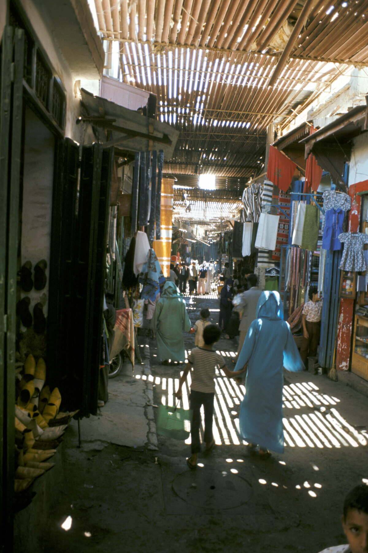 Marrakech (Morocco). Sale of fabrics and clothes i