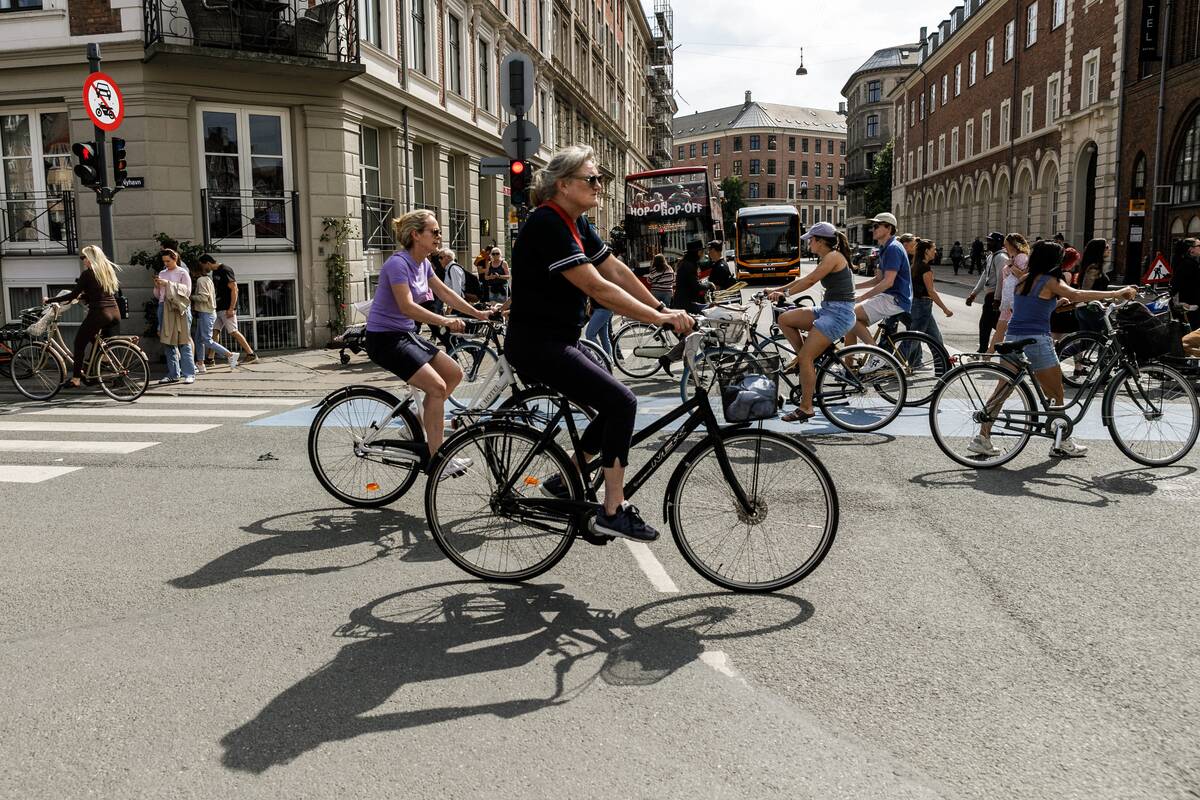 People are riding bicycles in the Nyhavn area, in the center...