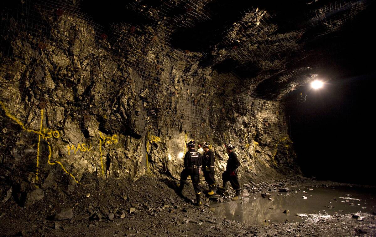 People look over an outcropping of a copper and nickel depos