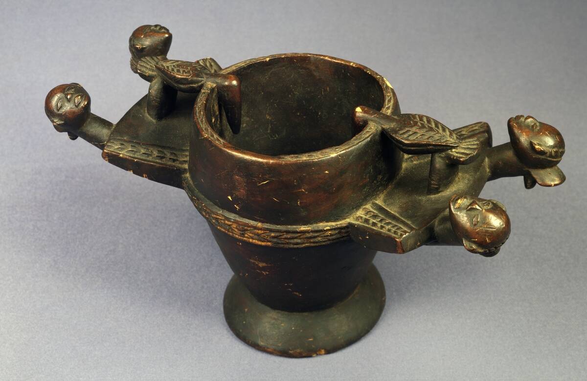 Wooden cup with head handles...