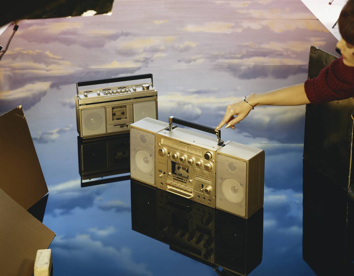 Young woman touching boom box