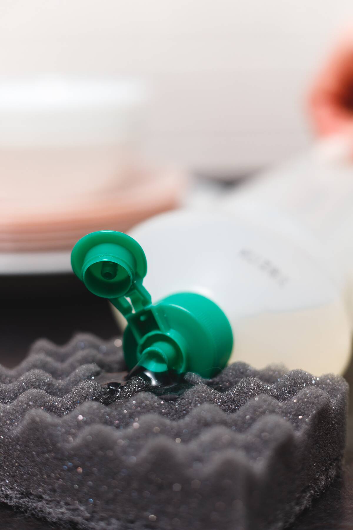 close-up-of-detergent-bottle-and-sponge-on-kitchen-2026-01-08-05-34-49-utc
