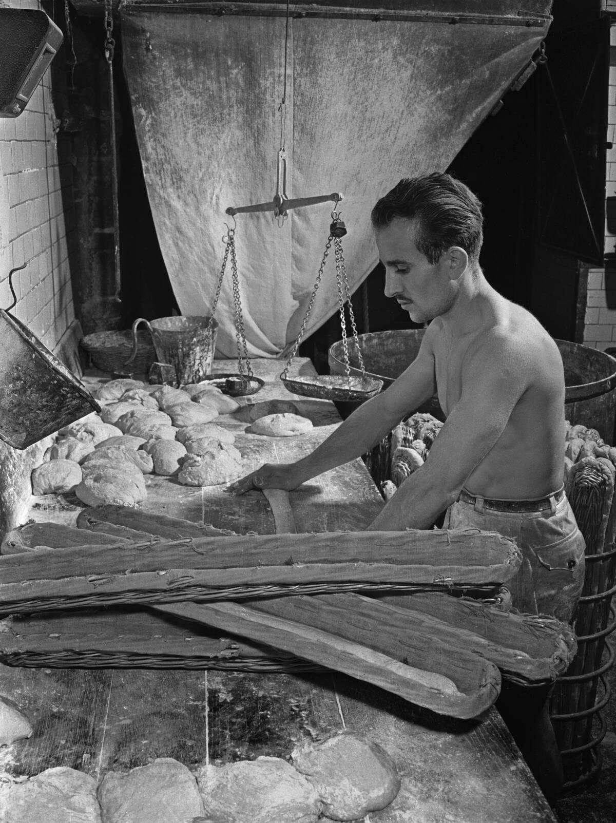 French Baker Rolling Dough for Baguettes