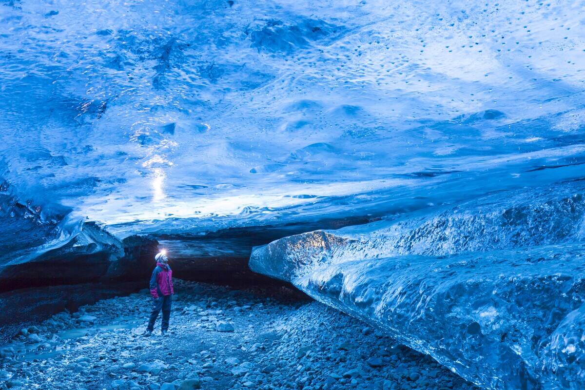 Tourist visiting The Crystal, natural ice cave in the Breiðamerkurjökull. Breidamerkurjokull Glacier in Vatnajökull National Park, Iceland