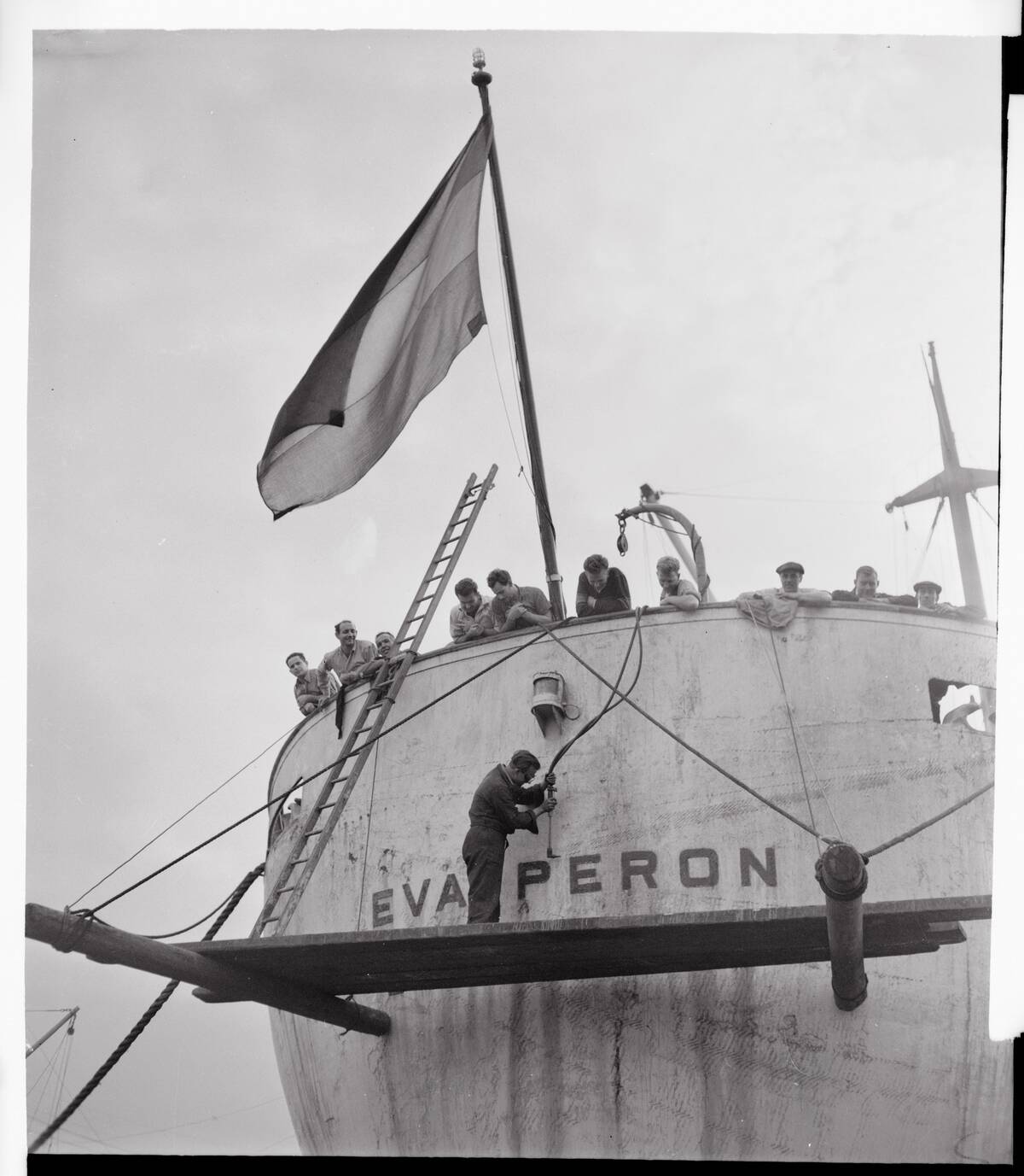 Workers Taking Lettering Off Ship