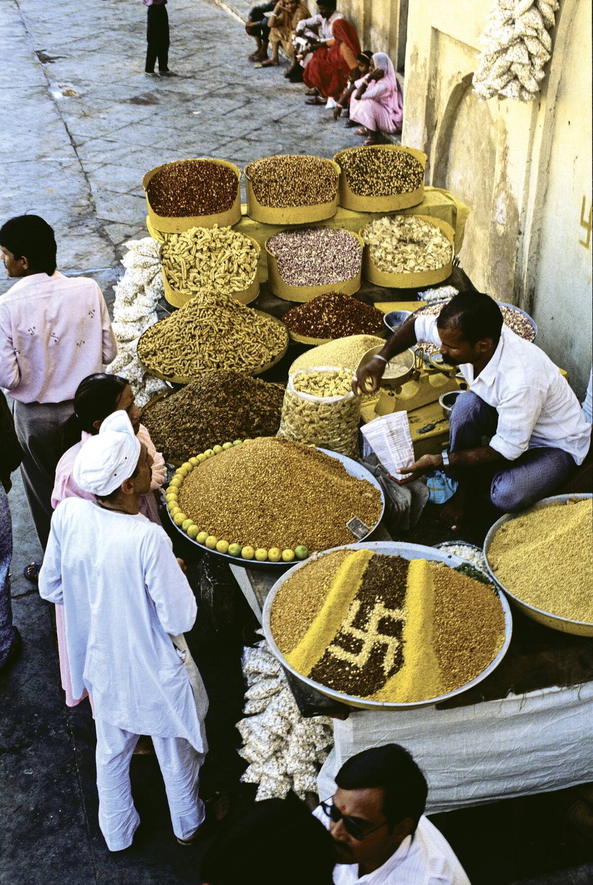 Indian marketplace with grains and spices showing the ancient charm symbol of a right-handed swastika (meaning good fortune