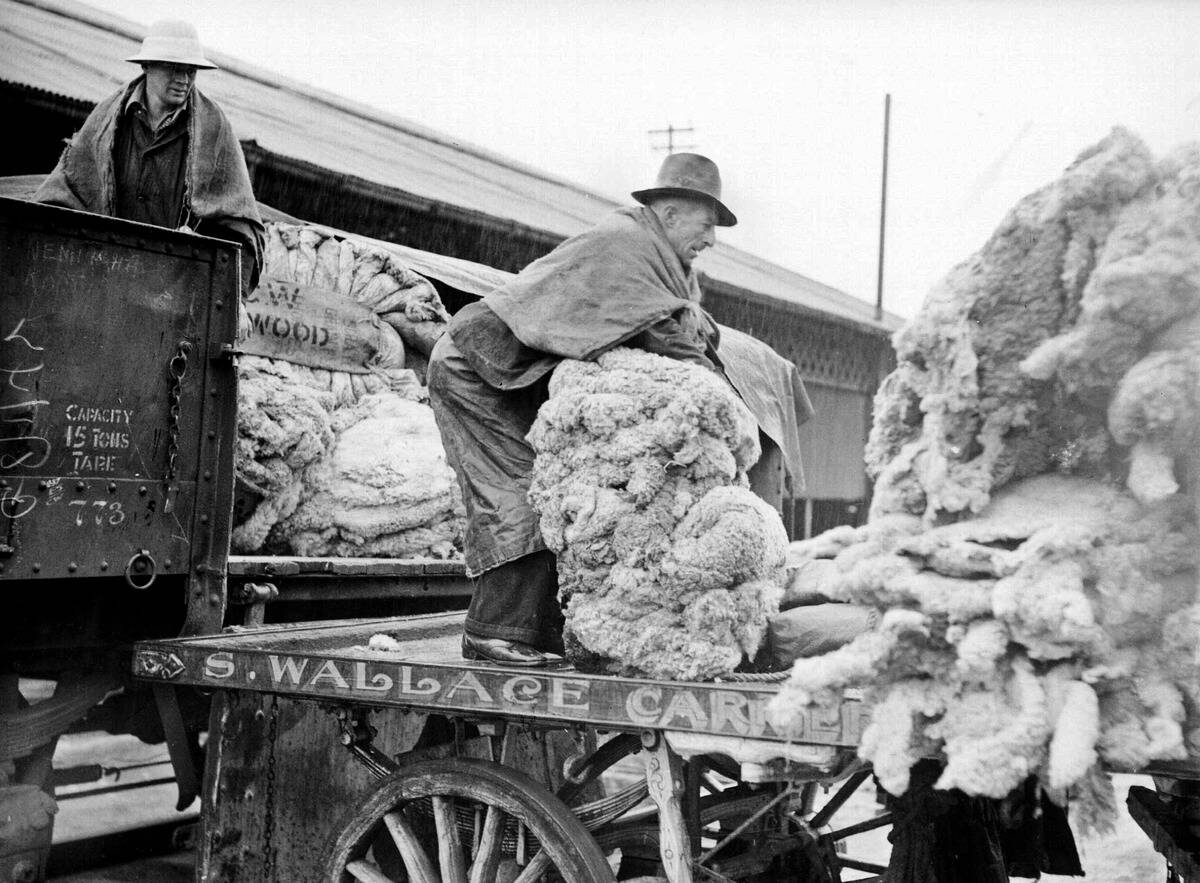 Men unloading wool in the rain at Darling Harbour Goods Yards in Sydney on 23 August 1938.