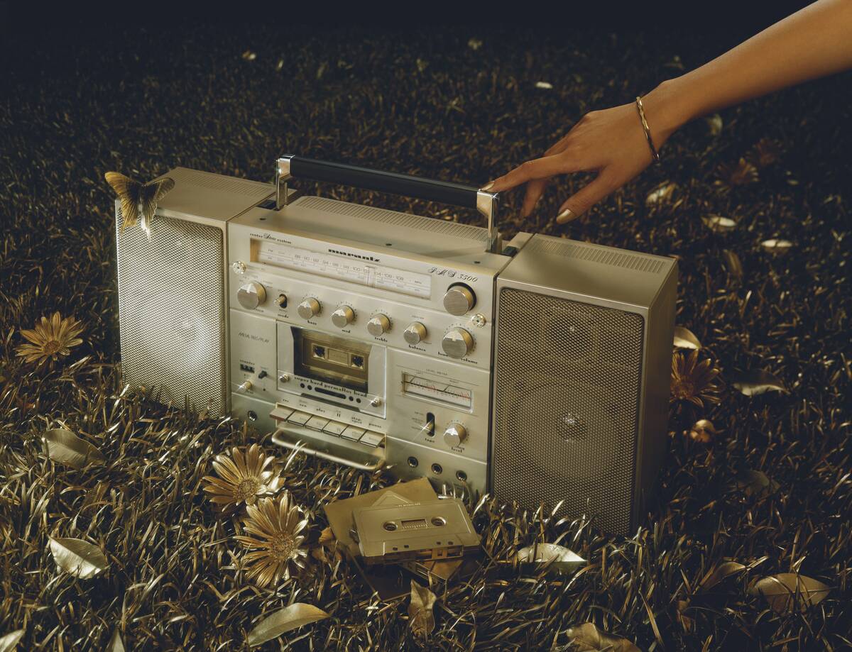 Woman hand touching boom box