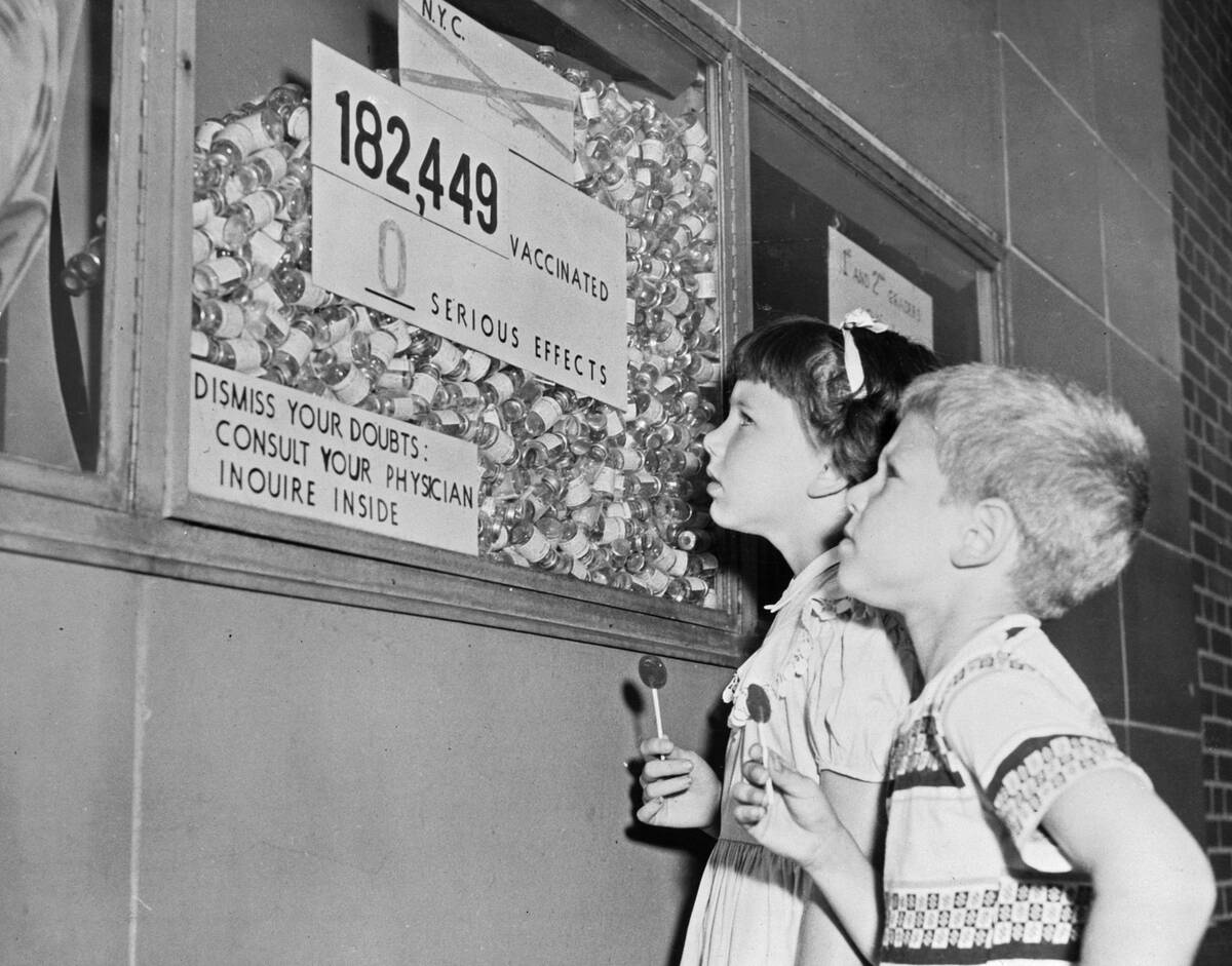 Youngsters Gazing up at Inoculation Statistics Display in Hallway