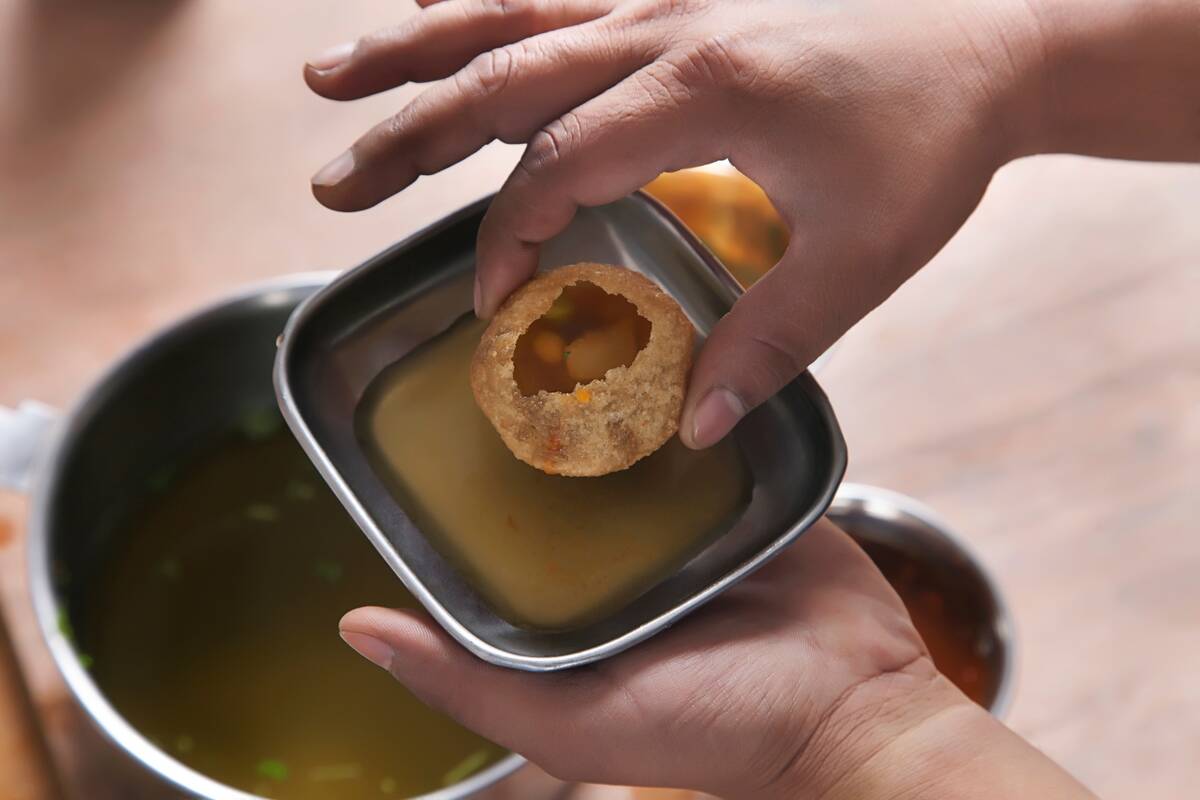 Cropped Image Of Man Having Panipuri