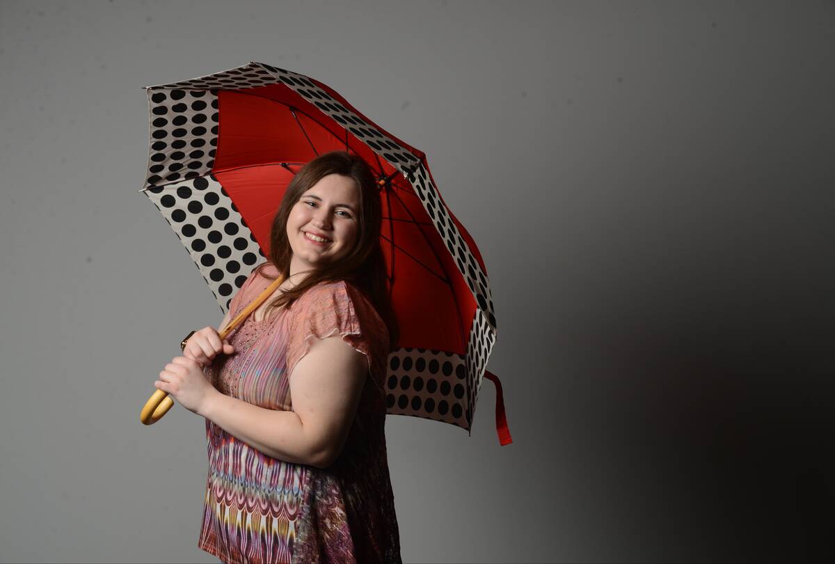 Voices Center Lucky Jennifer Wagner, a senior at Oley Valley, tests her luck by opening an umbrella indoors. Photo by Bill Uhrich 3/4/2018