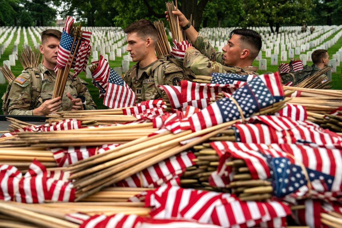 Annual Flags-In Event Held At Arlington Cemetery Ahead Of Memorial Day
